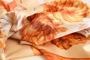 Macro detail showing smooth silk-like texture and vibrant floral prints on the scarf