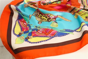 Detailed close-up of vibrant satin silk scarf featuring intricate colorful patterns and sheen
