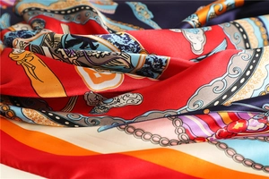 Macro shot of silk scarf fabric showing smooth texture and traditional Chinese motifs