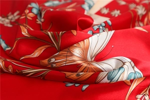 Macro shot of red silk scarf with realistic butterfly and floral print texture
