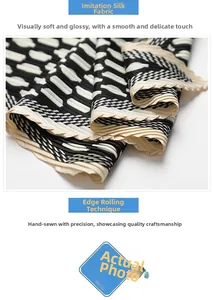 Macro detail of silk-like pleated scarf showing black and white patterns and hand-rolled edges