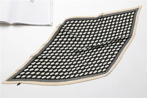 Close-up of diamond-shaped pleated scarf with black and white polka dot pattern