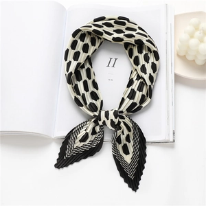 Detail of pleated black and white polka dot silk scarf with stylish wrinkle texture