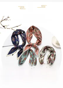 Detailed macro of four floral pleated silk scarves showing exquisite accordion textures