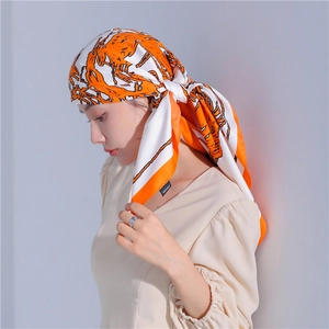 Detail of 100% silk scarf with horse print worn as a stylish headband for women