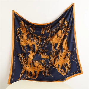 Detail view of the navy silk square scarf showing soft texture and orange horse print