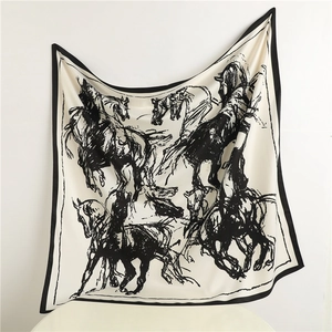 Detailed view of large square silk scarf with black hand-drawn horse print and soft texture