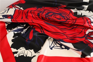 Close-up of elegant red rose silk scarf with smooth texture and fine stitched edges