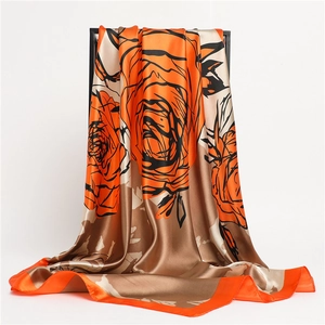 Detailed view of orange and brown rose floral print silk scarf with elegant drape