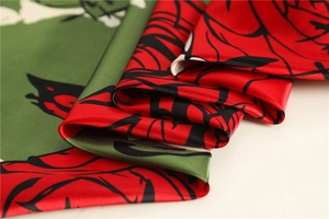 Close-up of red rose floral print on silky satin fabric with elegant fabric drapes