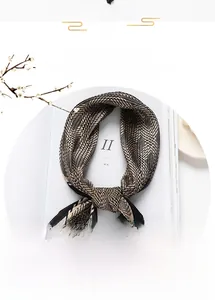 Detail of pleated silk scarf with geometric wavy patterns and elegant crinkle texture