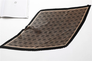 Macro view of pleated silk scarf with vintage geometric houndstooth pattern detail
