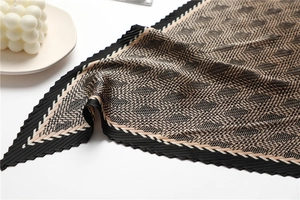 Detail of pleated silk-like scarf with black and beige geometric houndstooth pattern