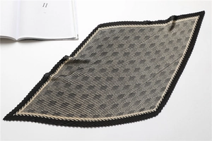 Detail of pleated rhombic scarf with houndstooth pattern on minimalist background