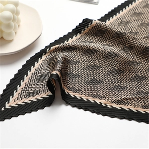 Houndstooth pleated silk scarf with geometric pattern and elegant serrated edges on white background