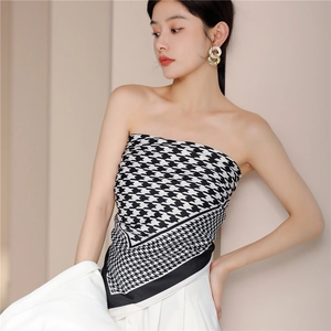 Classic houndstooth silk scarf worn as a stylish tube top under a white blazer suit