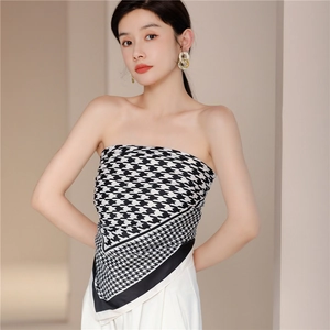 Detail of houndstooth silk scarf worn as a bandeau top with smooth texture