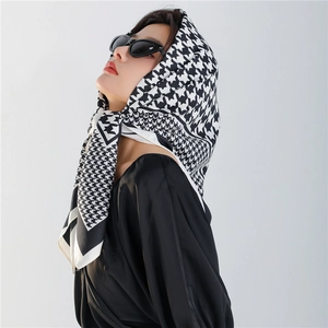Classic houndstooth silk scarf styled with black sunglasses for a retro fashion look