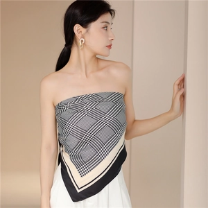 Detailed view of houndstooth silk scarf top with asymmetric hem and smooth texture