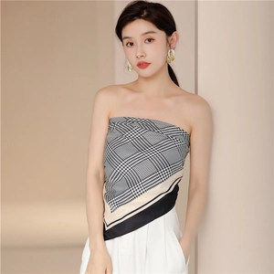Elegant houndstooth silk scarf worn as a stylish top with classic black and white pattern