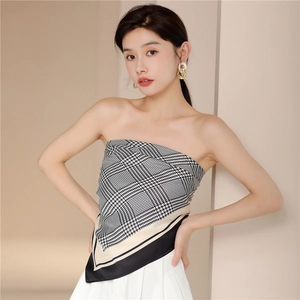Detail of silk-feel scarf worn as a top featuring classic black and white houndstooth pattern
