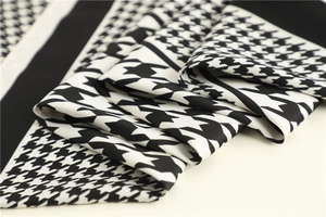 Macro shot of high-quality houndstooth silk scarf with classic black and white patterns