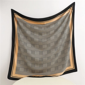 Detail of elegant houndstooth silk scarf showing drape and classic pattern layout