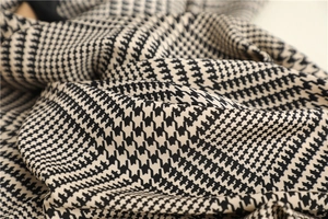 Macro shot of high-quality black and white houndstooth fabric with twill texture detail