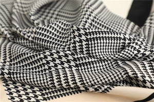Close-up of silk scarf with classic houndstooth pattern and elegant twill fabric texture