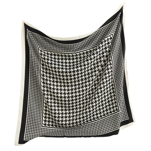Houndstooth pattern square silk scarf with black borders shown in a floating view