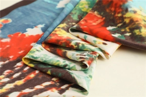 Detailed macro view showing the glossy texture and colorful oil painting patterns of the scarf