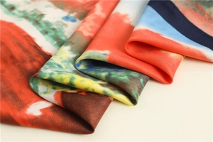 Macro detail of silk scarf showing vibrant abstract patterns and smooth shiny fabric texture