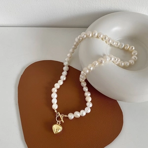 Elegant freshwater pearl necklace with gold heart pendant and OT toggle clasp closure