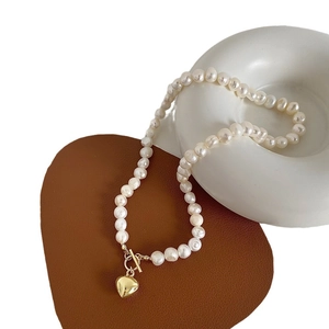 Elegant freshwater pearl necklace with gold heart pendant and vintage toggle clasp