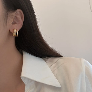 Minimalist gold geometric triple layer square hollow earrings for women on white shirt