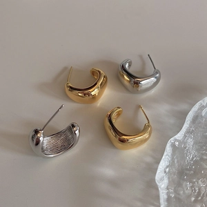Minimalist geometric C-shaped thick stud earrings in polished gold and silver finish