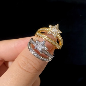 Double-layered gold and silver star rings with zircon stones on a model's hand