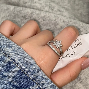 Macro shot of silver-plated star ring with pavé-set zircon on double-layer open band
