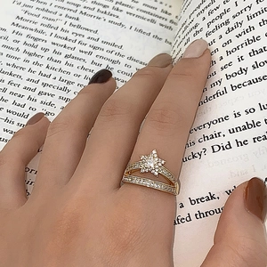 Close-up of golden hollow star ring with double-layer zircon pave on finger