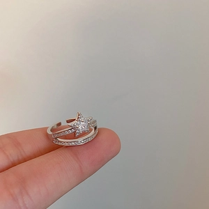 Detailed close-up of double-layer open ring featuring a sparkling zircon star design