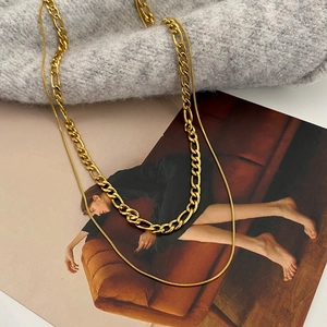 Minimalist double-layered gold snake and Figaro chain necklace in stainless steel