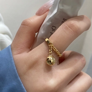 Close-up of a gold-plated adjustable chain ring featuring a polished solid bead charm