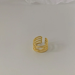 Detail of gold-plated multi-layer crossover ring featuring twisted rope textures