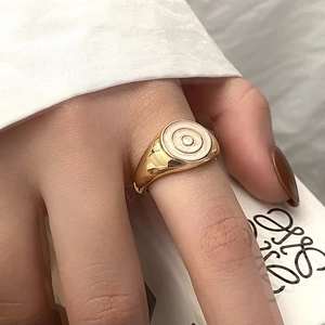 Close-up of a vintage gold-plated ring featuring a mother of pearl disc inlay