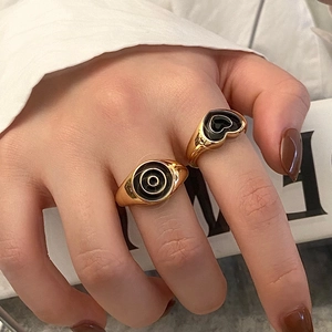 Vintage gold-plated rings with black enamel heart and circular patterns for women