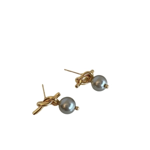 French vintage knotted gold stud earrings with elegant grey pearls on white background