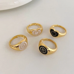Detail view of a 4-piece vintage heart and round enamel ring set in gold-plated finish