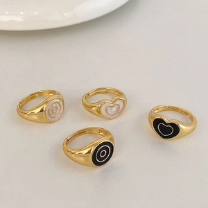 Set of four gold-plated vintage heart and circle enamel rings in black and white
