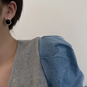Detailed view of vintage style ear studs with black stone and silver twisted metal base