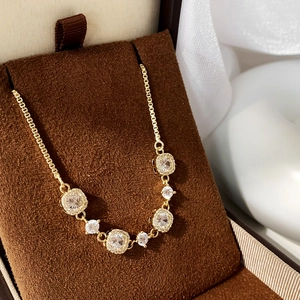 Macro view of gold chain bracelet with seven sparkling zircon stones in a plush jewelry box